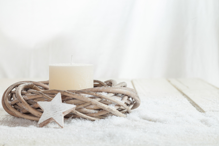 Christmas decoration, white candle and wreath, wooden star, copy spaceの写真素材