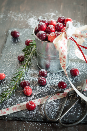 Cranberries in small zinc bucket, decorated for Christmasの写真素材