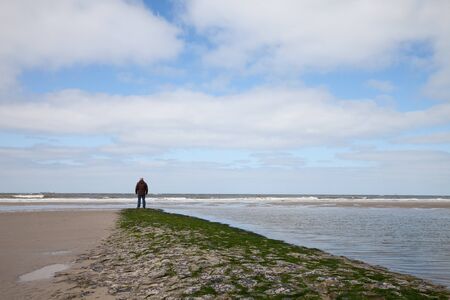 Germany, Wangerooge, North Sea, man on the coastの写真素材