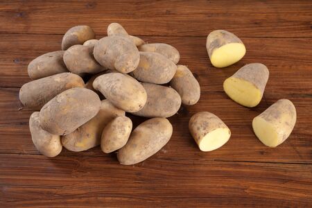 Potatoes on wood, halfedの写真素材
