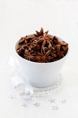 Christmas arrangement, bowl with star anis, white woodの写真素材