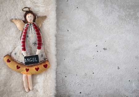 Christmas decoration, angel on plush, concrete, copy spaceの写真素材