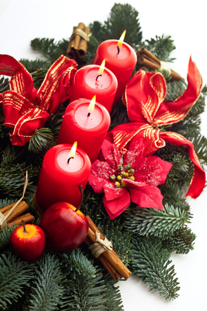 Christmas floral arrangement with red candelsの写真素材