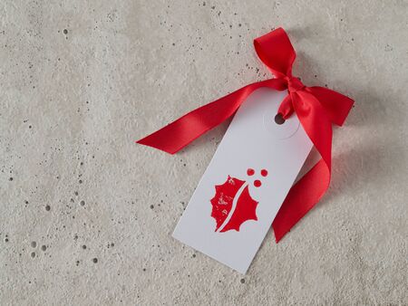 Christmas, gift tag, red ribbon, background concreteの写真素材