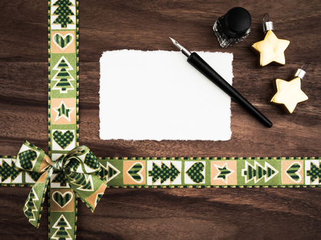 Christmas, gift ribbon on wood, christmas decoration, blank card, quillの写真素材