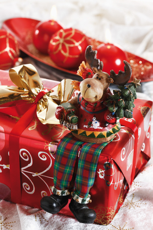 Christmas figurine on Christmas parcel, close-upの写真素材