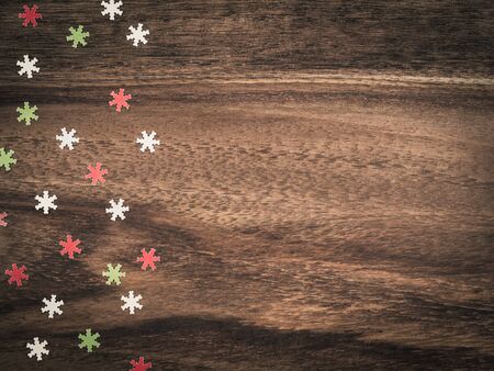 Christmas, colorful paper snowflakes on wood, copy spaceの写真素材