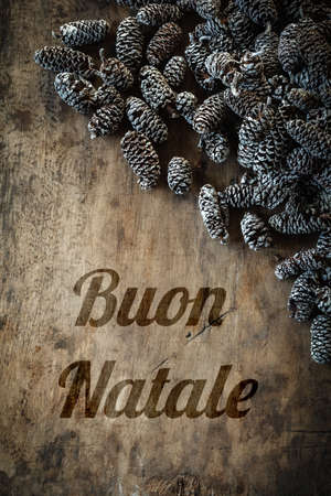 Wooden background with cones, Italian wishesの写真素材