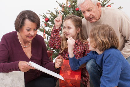 Grandchilds showing list of Christmas giftsの写真素材