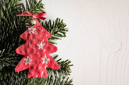 Christmas decoration, evergreens, white wood, red christmas treeの写真素材