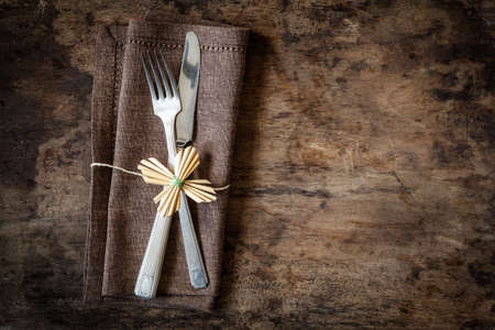 Christmas time, decorated cutlery, brown napkin, copy spaceの写真素材