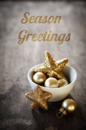 Christmas decorations in bowl, English wishes, Season Greetingsの写真素材