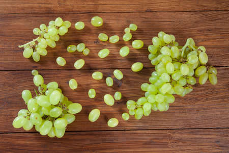 Green grapes on woodの写真素材