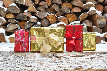 Christmas presents in front of woodpileの写真素材
