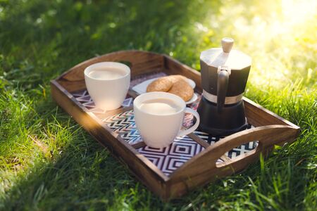 Picknick, coffee cups, espresso maker and cookies on trayの写真素材