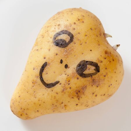 Heart shaped potato with happy faceの写真素材