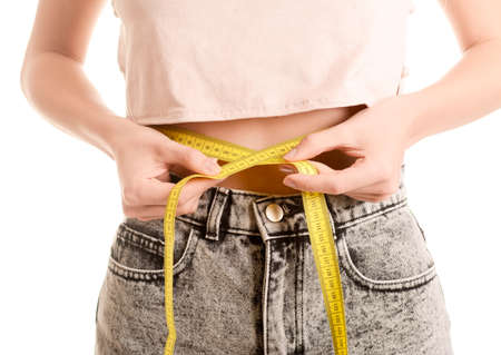 Young woman measuring abdominal girthの写真素材