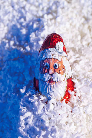 Chocolate santa claus in artificial snowの写真素材