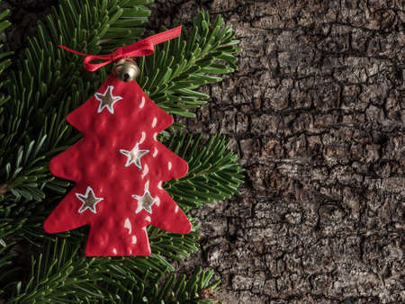 Christmas decoration on bark, evergreens, christmas tree of metal