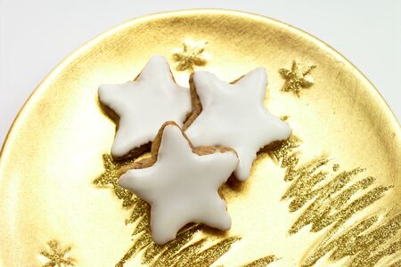Christmas biscuits, Cinnamon stars on golden plateの写真素材
