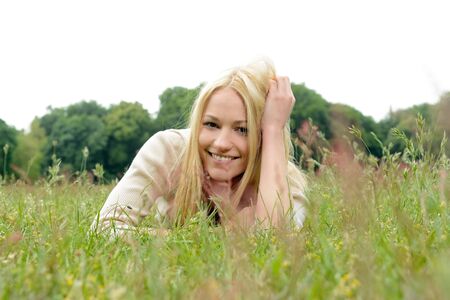 Young woman laying on meadowの写真素材