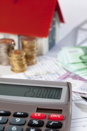 Model house calculator euro notes and coins on blueprint, planning constructionの写真素材