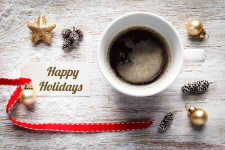Christmas time, festive still life, cup of coffee, happy holidays, sign on woodの写真素材