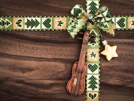 Christmas, gift ribbon on wood, christmas decoration, violin and starの写真素材