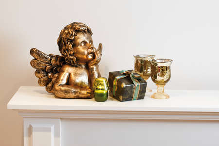 Angel figurine and decoration on shelfの写真素材