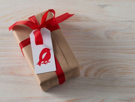 Christmas present with gift tag, printed, red ribbonの写真素材