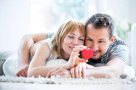 Happy loving couple, heart box in handの写真素材