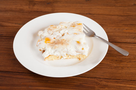 Piece of nectarine cream cake on plateの写真素材