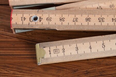 Folding rule on woodの写真素材