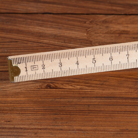 Folding rule on woodの写真素材