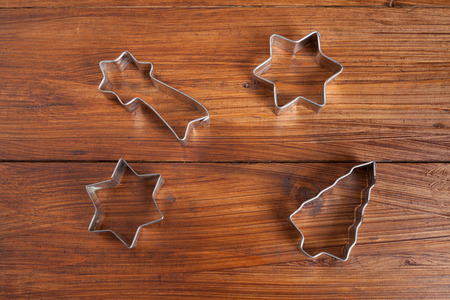 Biscuit cutter for christmas cookies on woodの写真素材