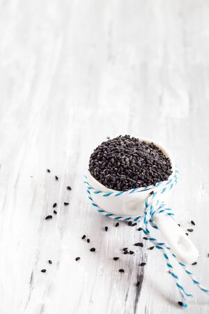 Black cumin (Nigella sativa) in small porcelain bowlの写真素材