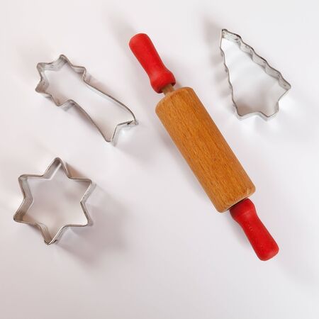 Biscuit cutter for christmas cookies, rolling pin, white backgroundの写真素材