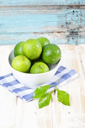Bowl of limes on napkin,close upの写真素材