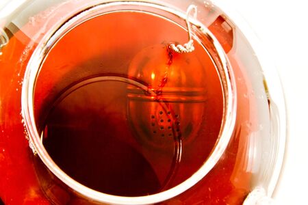 Tea egg in teapot, hot water, red fruit teaの写真素材