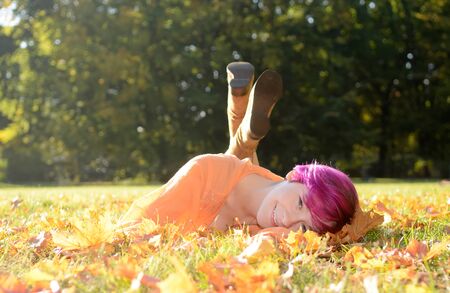 Young woman in park in autumnの写真素材