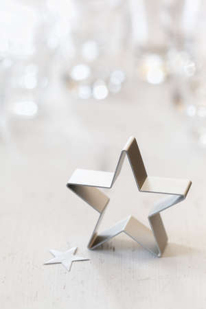 Christmas decorations, silver, star shape, cutter, white wood