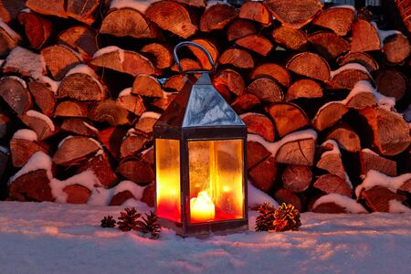 Storm lampand cones in winter, woodpileの写真素材