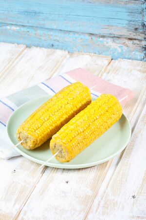 Plate of skewered corn cob on napkin,close upの写真素材
