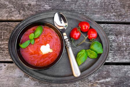 Homemade tomato soup with basil, chilli threadsの写真素材