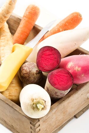 Wooden box with parsley root, beetroot, parsnips, white and red radishの写真素材
