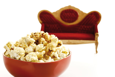 Popcorn in bowl, sofa in background, close-upの写真素材