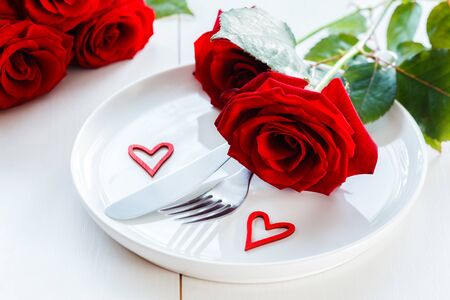 Valentine invitation, Red roses on plate with red heartsの写真素材