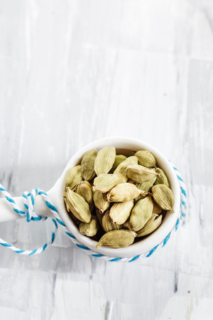Green cardamom pods (Amomum subulatum) in small bowlの写真素材
