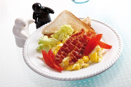 Scrambled eggs with ham on plate, elevated viewの写真素材