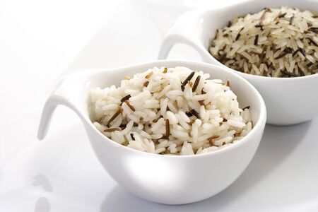 Sorts of Rice in bowls, raw and cookedの写真素材